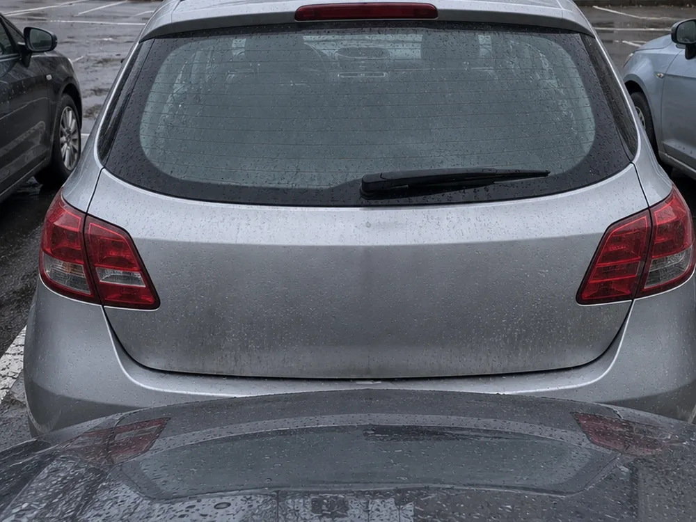 Zastawione miejsce parkingowe – srebrne auto blokuje wyjazd innemu samochodowi na osiedlowym parkingu